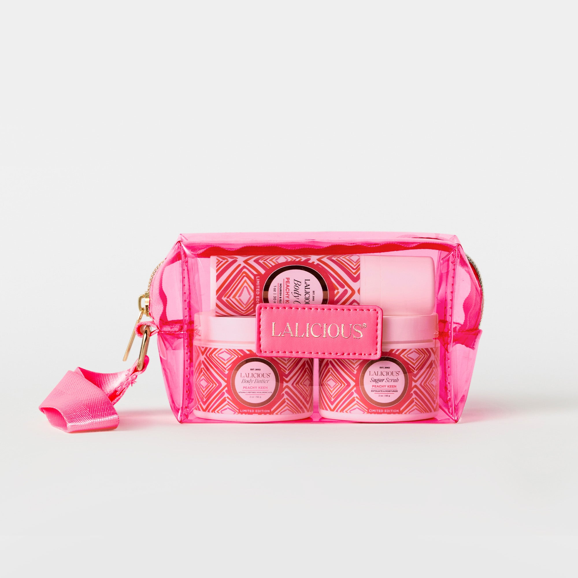 Peachy Keen Travel Set- 2oz sugar scrub jar, 2oz body butter jar and 1oz Body oil in the pink bag on a white background.