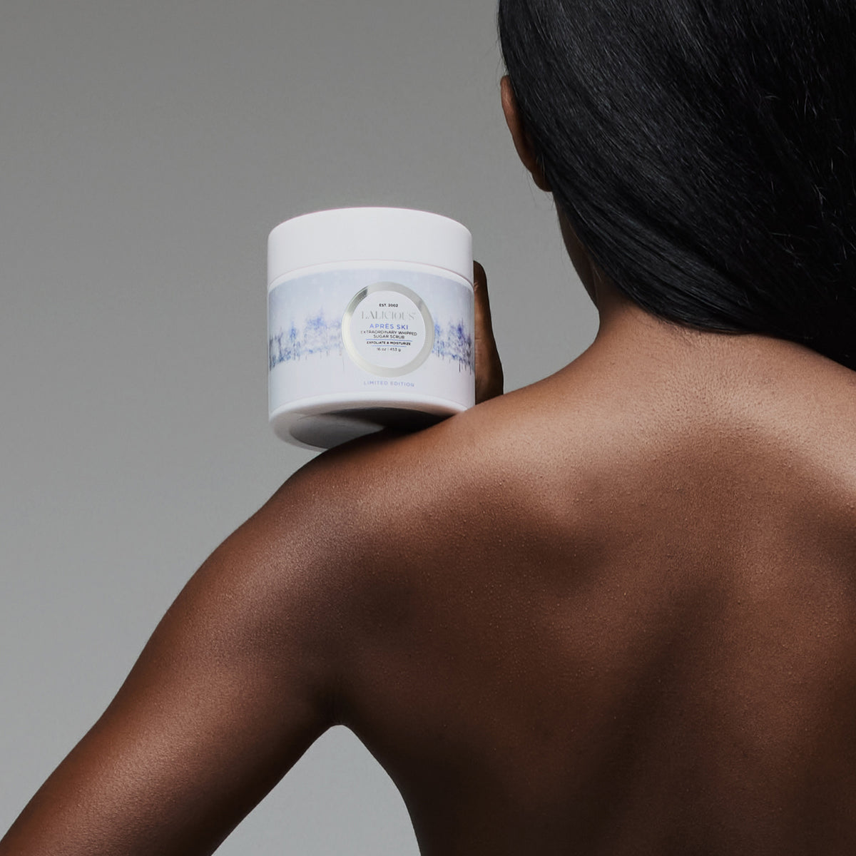Woman holding a 16oz of Après Ski Scrub over shoulder LALICIOUS