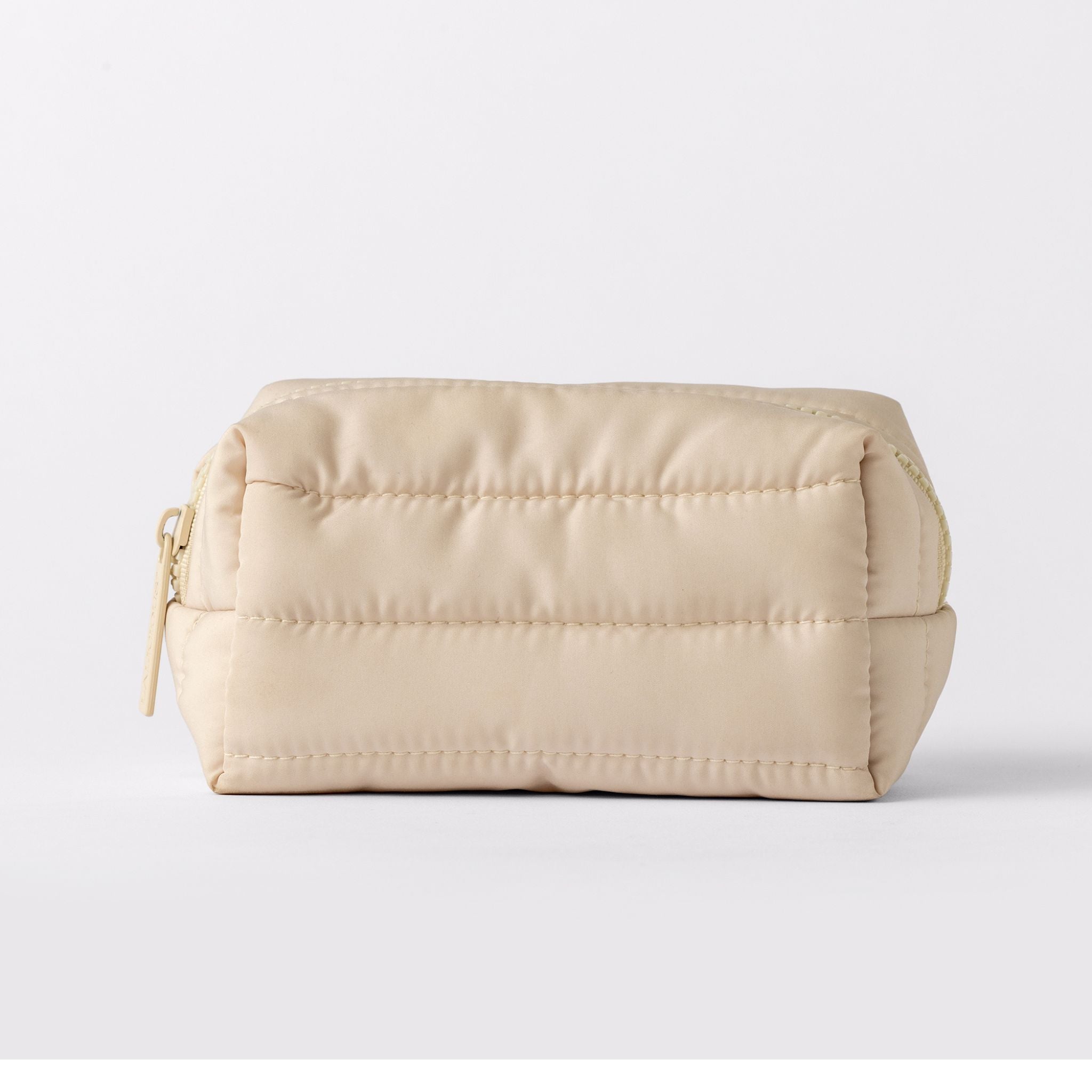 LALICIOUS Pumpkin SPice bag. A light beige quilted nylon cosmetic pouch with a gold zipper, shown against a plain light gray background.
